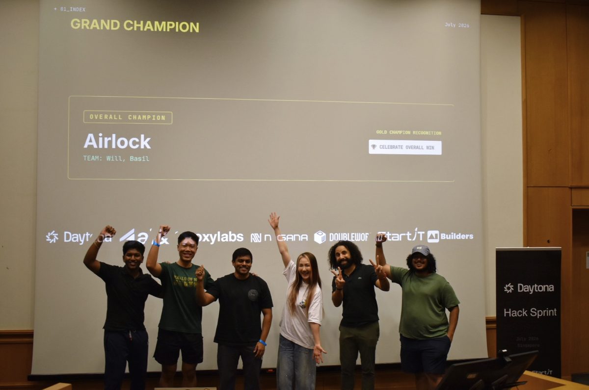 Airlock announced as overall champion on the projector at the Daytona HackSprint, with the team standing in front of it.